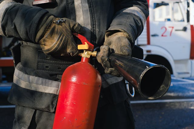 firefighter holding a fire extinguisher