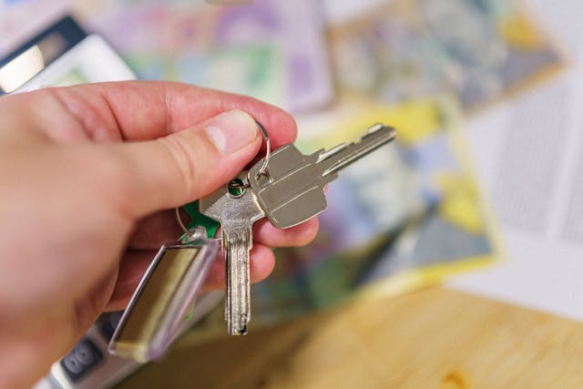 a hand holding up a set of keys